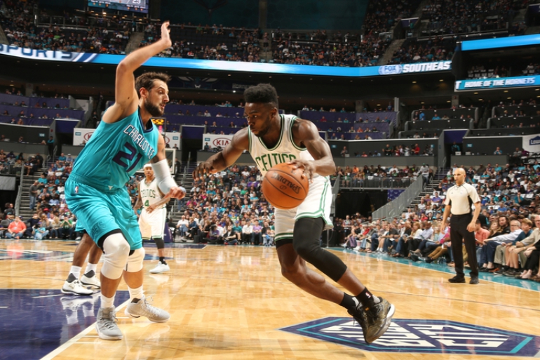 CHARLOTTE, NC - OCTOBER 29: Jaylen Brown #7 of the Boston Celtics handles the ball against Marco Belinelli #21 of the Charlotte Hornets during a game on October 29, 2016 at the Spectrum Center in Charlotte, North Carolina. NOTE TO USER: User expressly acknowledges and agrees that, by downloading and or using this photograph, user is consenting to the terms and conditions of the Getty Images License Agreement. Mandatory Copyright Notice: Copyright 2016 NBAE (Photo by Kent Smith/NBAE via Getty Images)